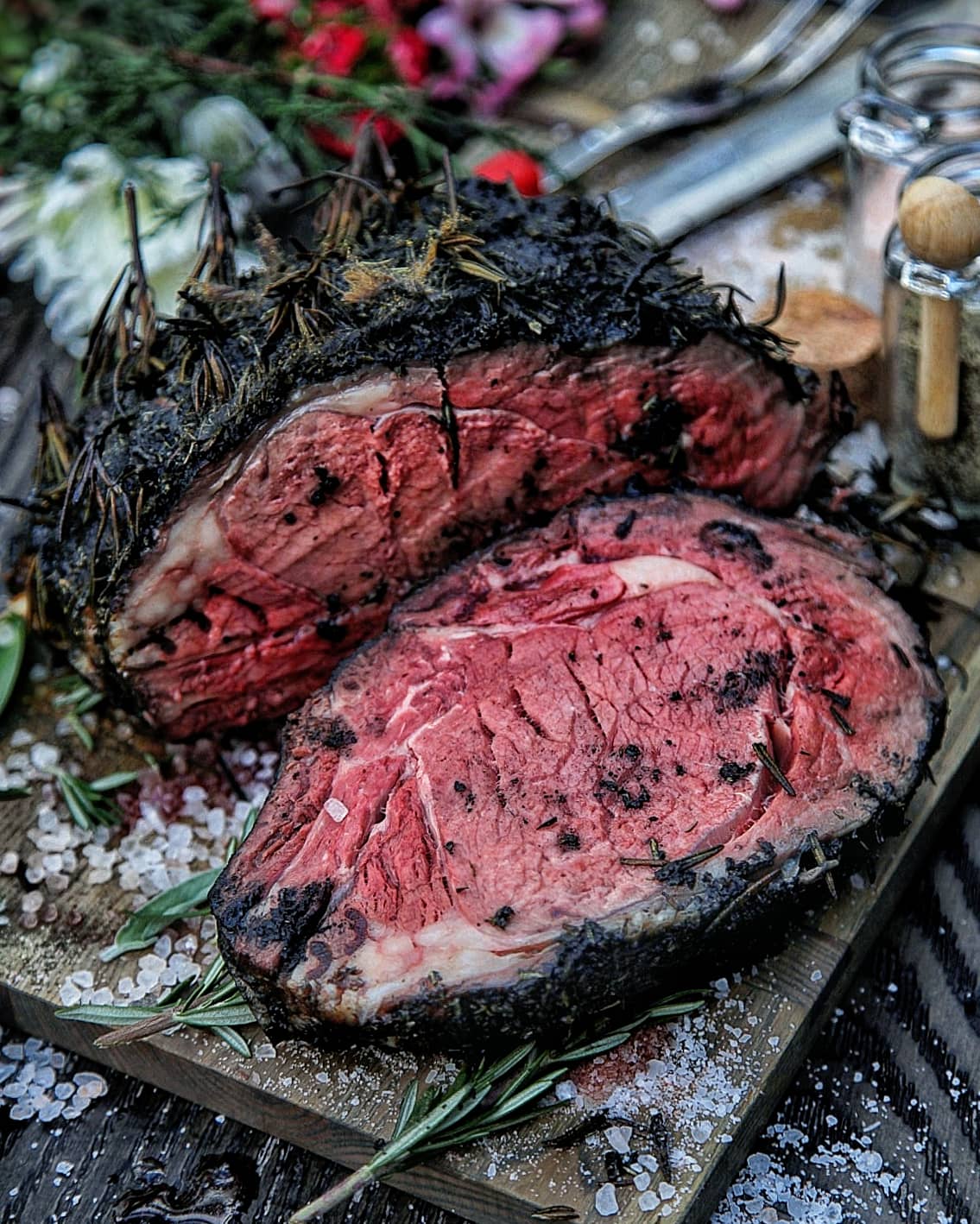Rosemary and roasted garlic-encrusted smoked prime rib! If you're looking to take your grilling game up a notch, this recipe is the perfect opportunity to flex those smoking muscles and impress everyone around you.