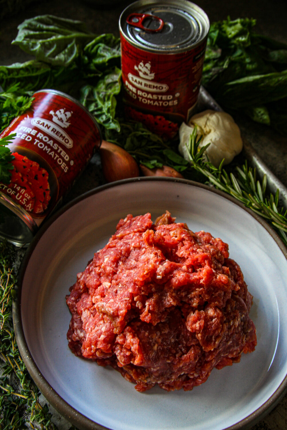ground lamb, canned tomatoes and herbs