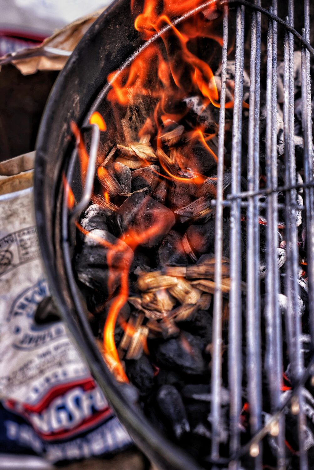 Ignite the grill with a pile of charcoal and set up for 2 zone grilling.