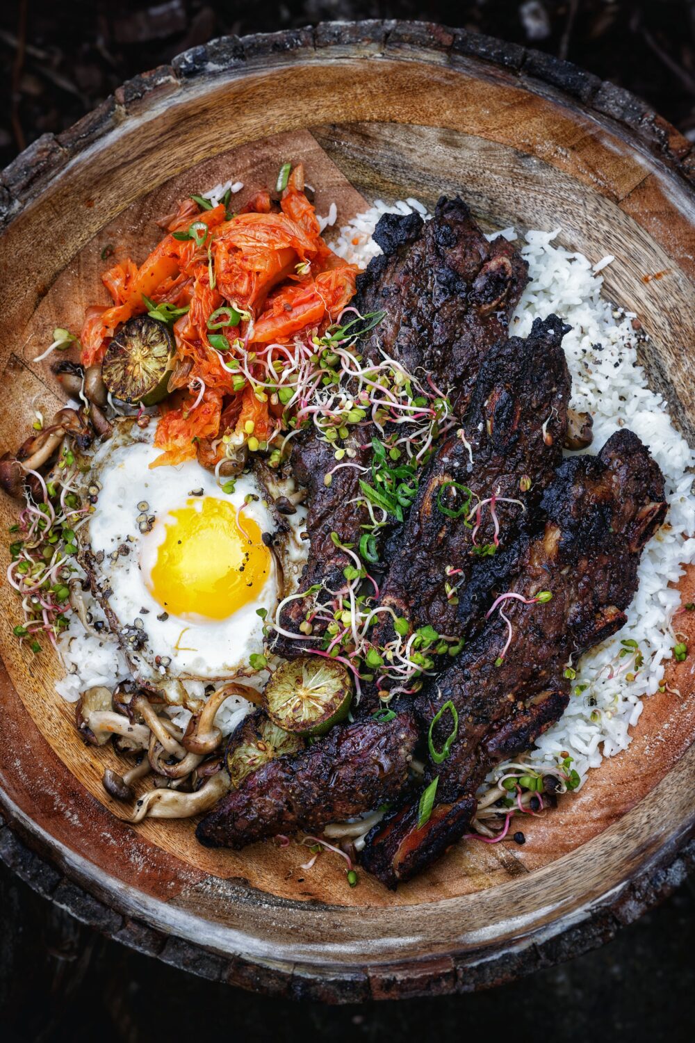Plated atop a bed of al dente rice, kimchi, a fried egg and mushrooms, then finished in fresh herbs. The ultimate dish featuring Central American-inspired flanken beef ribs.
