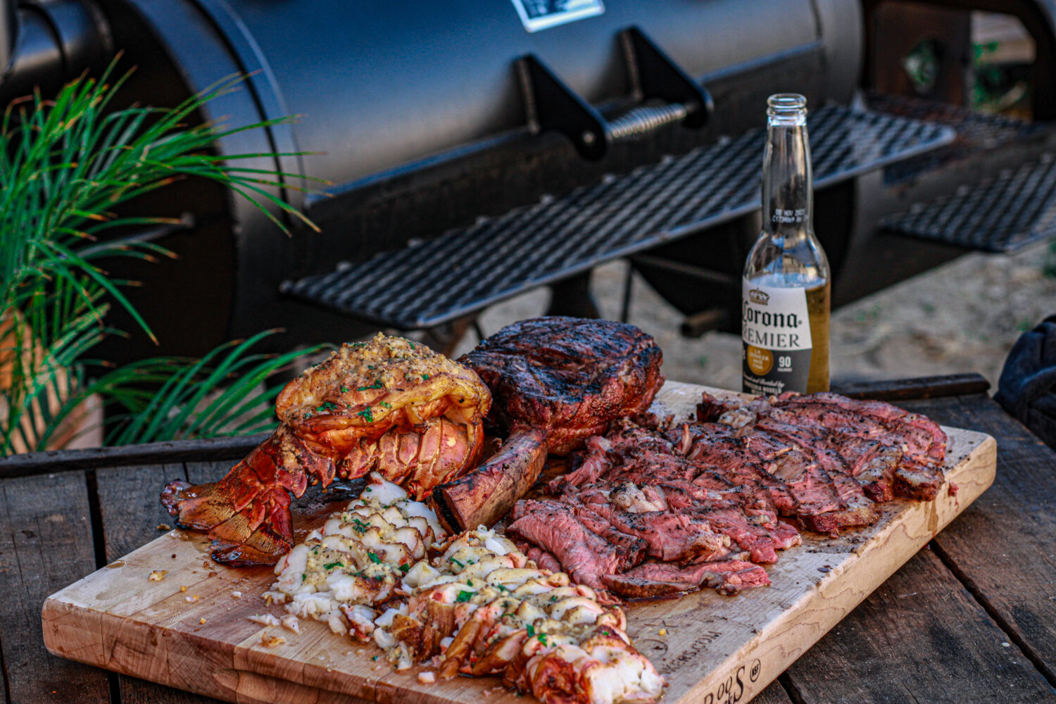 reverse seared tomahawk ribeyes and smoked lobster tails